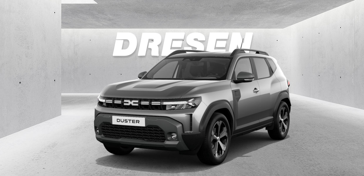 Grauer Dacia Duster vor Betonwand mit großem ‚DRESEN‘-Schriftzug darüber.