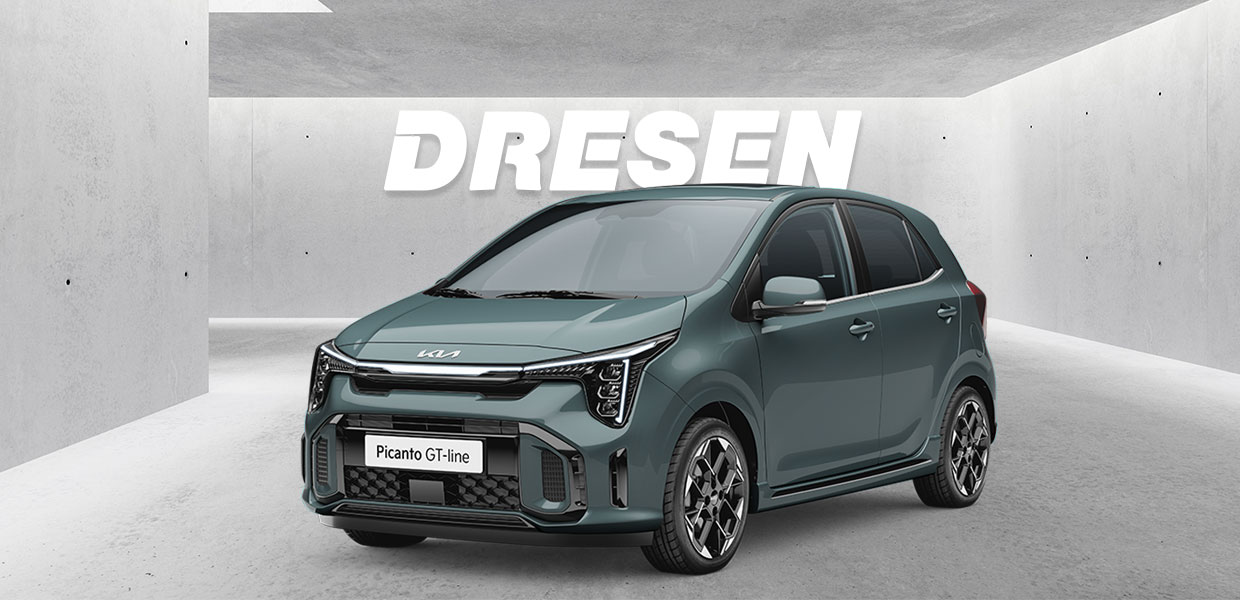 Grüner Kia Picanto vor Betonwand mit großem ‚DRESEN‘-Schriftzug darüber.