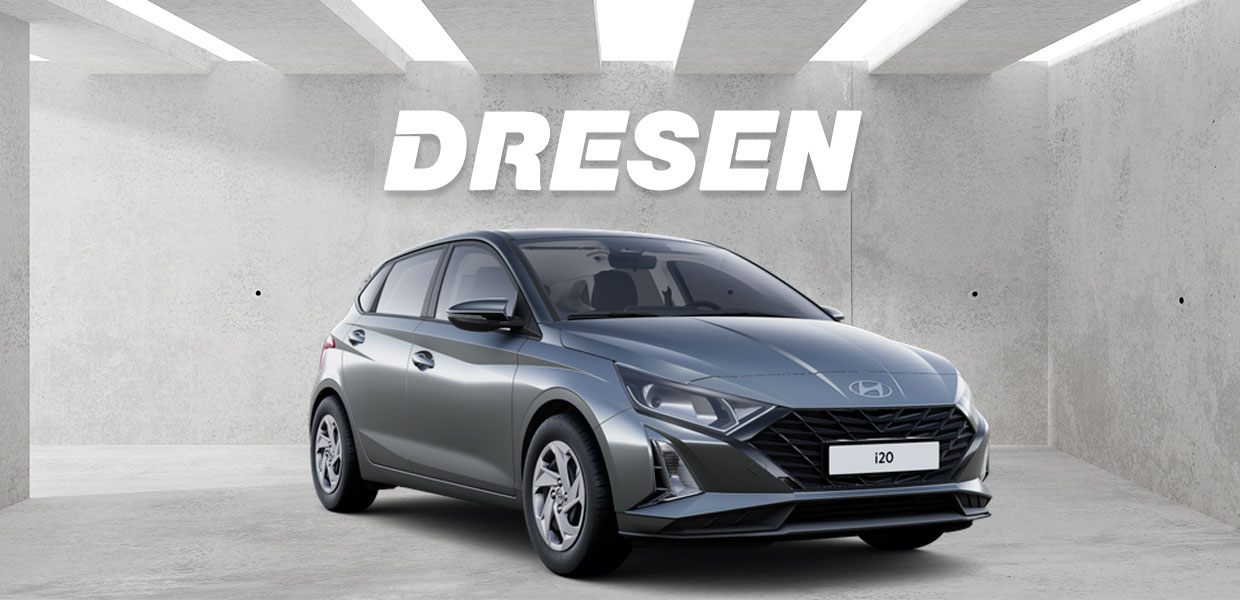 Grauer Hyundai i20 vor Betonwand mit großem ‚DRESEN‘-Schriftzug darüber.